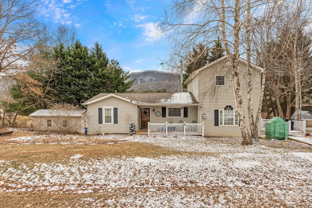 view of front of property featuring a mountain view and covered porch