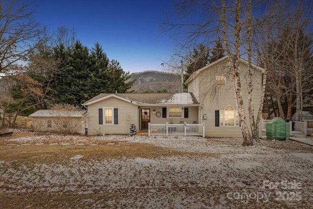 view of front facade featuring a mountain view and covered porch