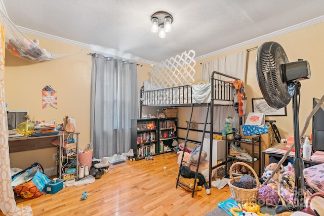 bedroom featuring crown molding, hardwood / wood-style floors, and a textured ceiling