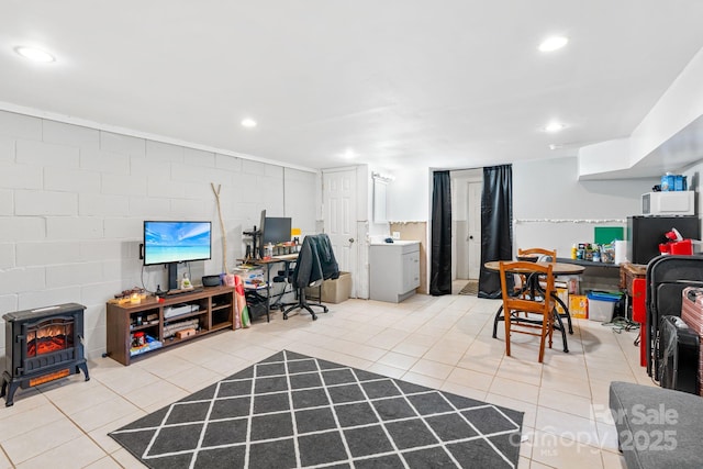 office featuring a wood stove and light tile patterned floors