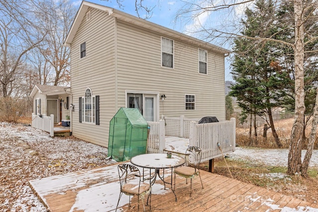 rear view of property featuring a deck