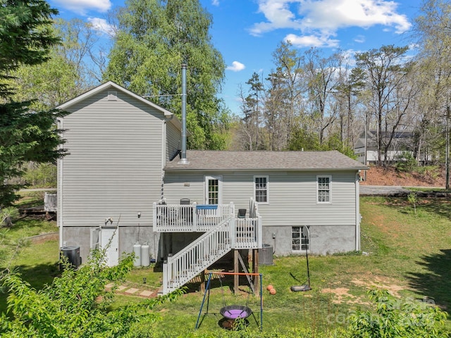 rear view of property with stairway, a lawn, a shingled roof, cooling unit, and a wooden deck
