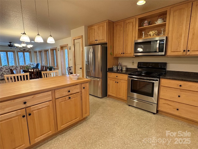 kitchen featuring appliances with stainless steel finishes, a textured ceiling, wood counters, decorative light fixtures, and a chandelier