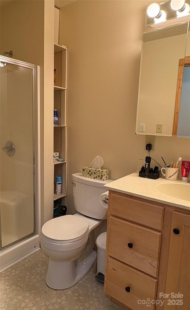 bathroom with vanity, toilet, and an enclosed shower