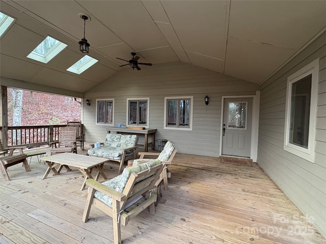 deck with outdoor lounge area and ceiling fan