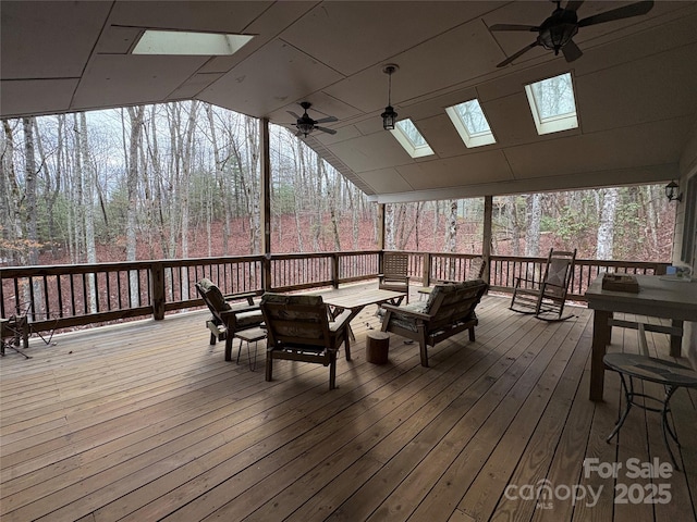 wooden deck featuring ceiling fan