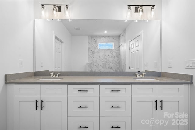 bathroom with vanity and a tile shower