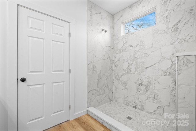 bathroom featuring tiled shower and hardwood / wood-style floors