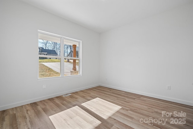 unfurnished room with light wood-type flooring