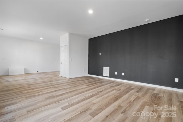 empty room with light hardwood / wood-style floors