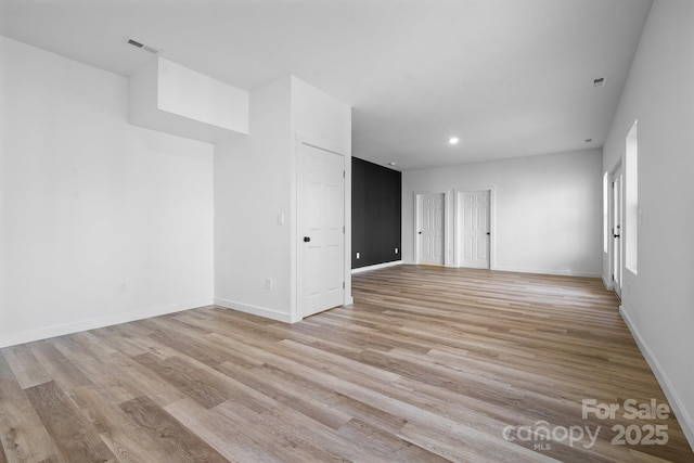 empty room with light hardwood / wood-style floors