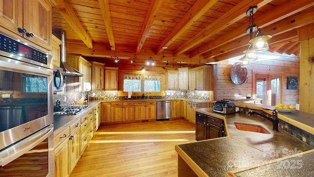 kitchen with hanging light fixtures, stainless steel appliances, wooden ceiling, beam ceiling, and light hardwood / wood-style flooring