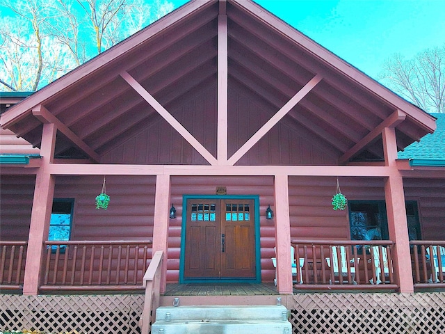 view of exterior entry featuring a porch