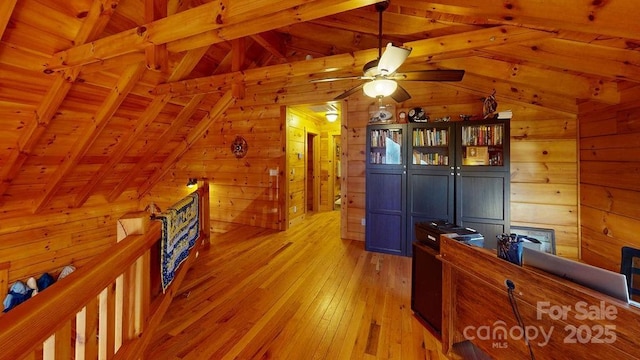 office with wood walls, wood ceiling, lofted ceiling with beams, ceiling fan, and light hardwood / wood-style floors