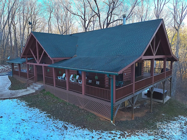 view of snow covered rear of property