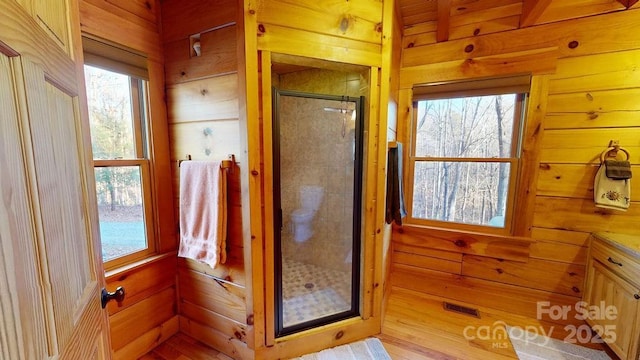 714 Heartwood Dr, Marion, NC 28752 - bathroom featuring a stall shower and wood walls