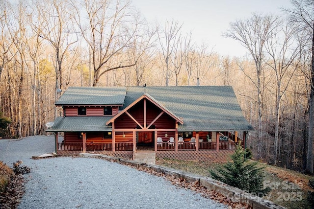 714 Heartwood Dr, Marion, NC 28752 - log-style house featuring covered porch, roof with shingles, and a forest view