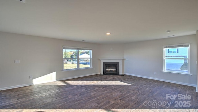 unfurnished living room featuring dark wood-type flooring