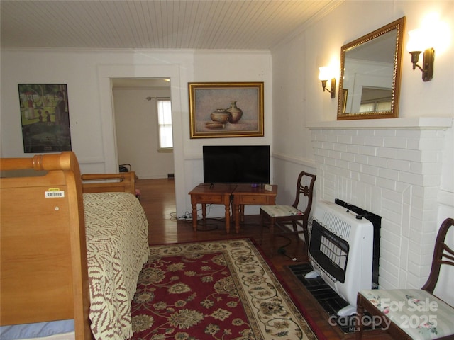 living room featuring heating unit, wooden ceiling, wood finished floors, and ornamental molding