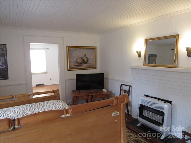 living room featuring heating unit, visible vents, wood ceiling, and ornamental molding
