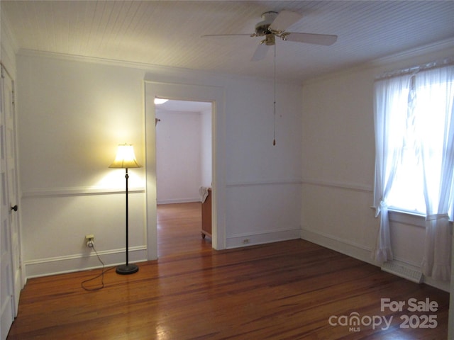 unfurnished room featuring crown molding, wood finished floors, a healthy amount of sunlight, and a ceiling fan