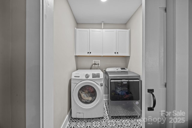 laundry room featuring cabinets, washing machine and dryer, and light tile patterned floors