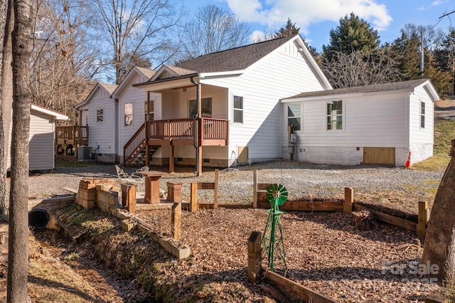 back of house featuring central AC unit