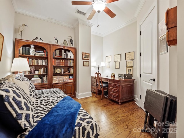 bedroom with hardwood / wood-style flooring, ornamental molding, and ceiling fan