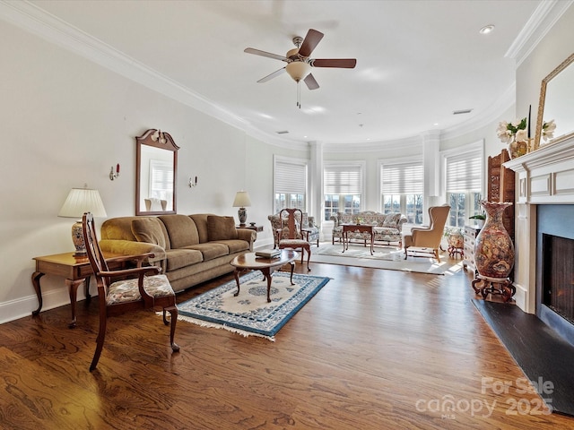 living room featuring wood-type flooring, ceiling fan, and crown molding