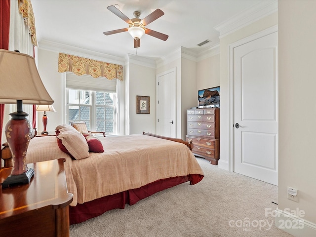 carpeted bedroom featuring crown molding and ceiling fan