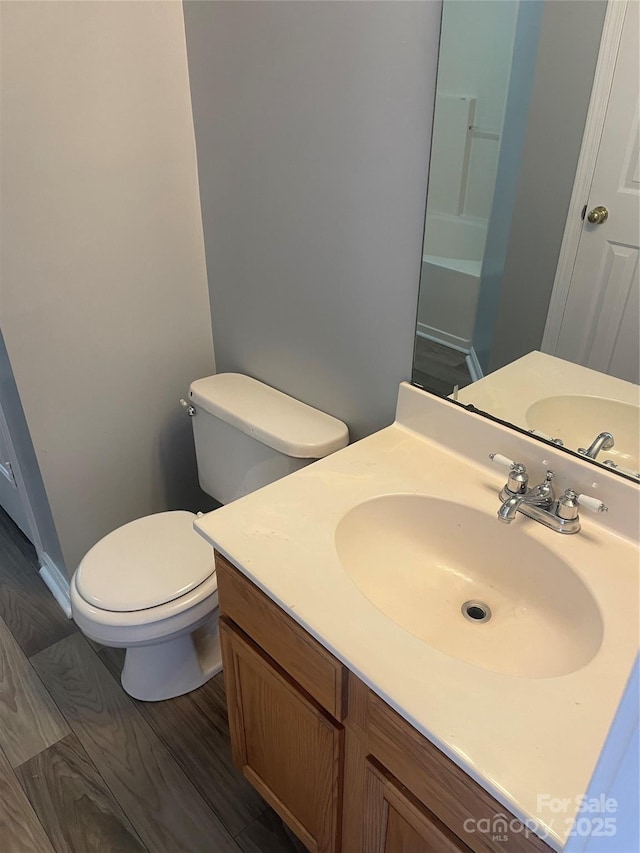 bathroom featuring toilet, a shower, and vanity