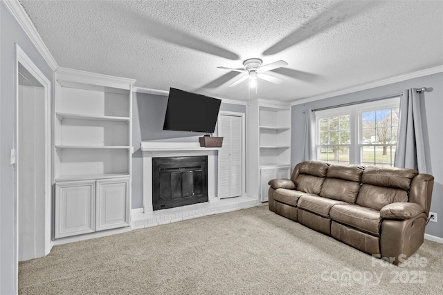 living room featuring ceiling fan, crown molding, a brick fireplace, light carpet, and a textured ceiling