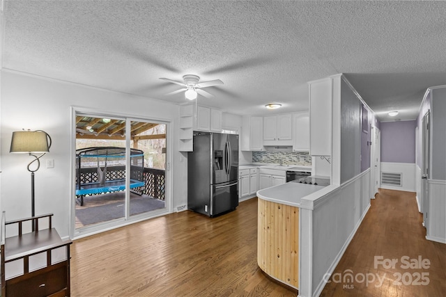 kitchen with white cabinetry, dishwasher, kitchen peninsula, stainless steel refrigerator with ice dispenser, and dark wood-type flooring