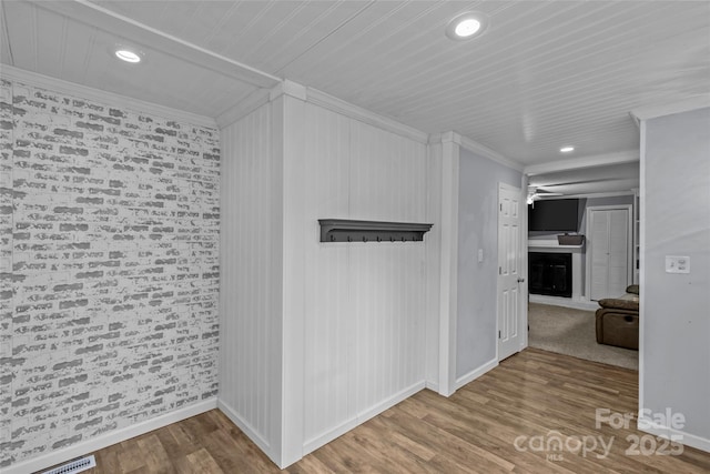 interior space with hardwood / wood-style floors and ornamental molding