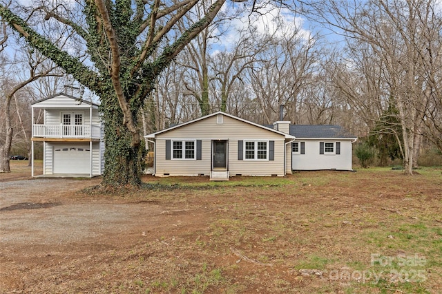 view of front of home featuring a garage and a balcony