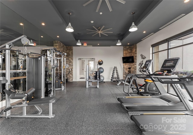 gym featuring a tray ceiling