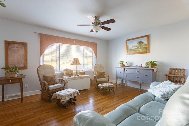 living room featuring ceiling fan and hardwood / wood-style floors