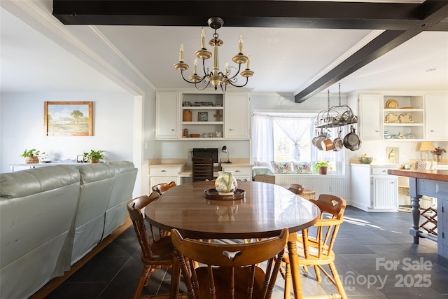 dining area with beamed ceiling, ornamental molding, and an inviting chandelier