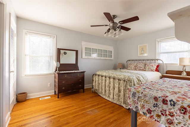 bedroom with ceiling fan and light wood-type flooring