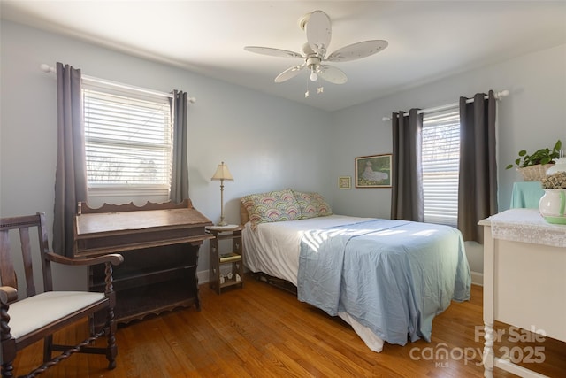 bedroom with wood-type flooring and ceiling fan