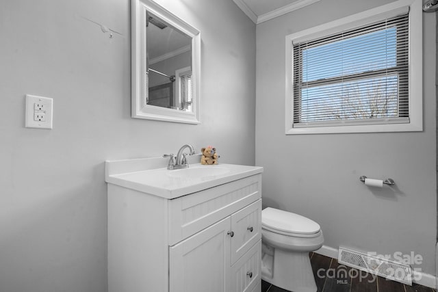 bathroom with hardwood / wood-style flooring, ornamental molding, toilet, and vanity