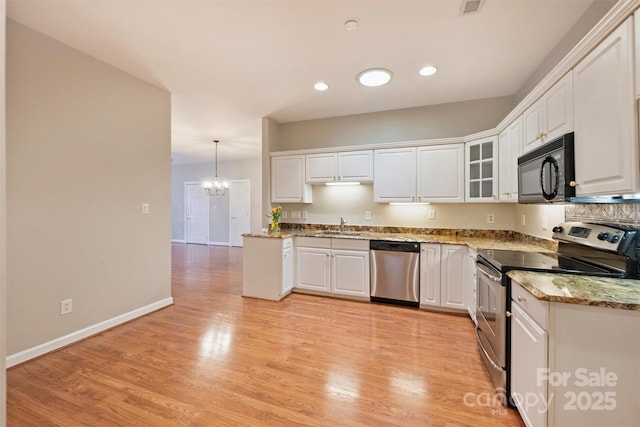 kitchen with a notable chandelier, decorative light fixtures, white cabinets, and appliances with stainless steel finishes