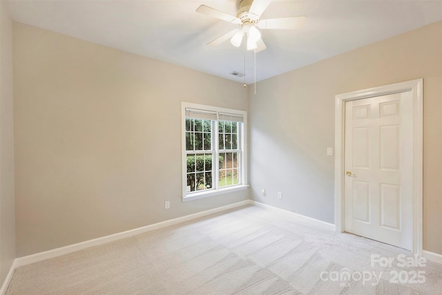 carpeted spare room featuring ceiling fan