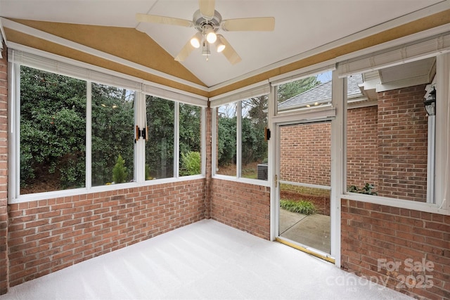 unfurnished sunroom with lofted ceiling and ceiling fan