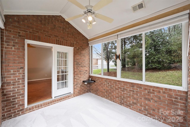 unfurnished sunroom with lofted ceiling and ceiling fan