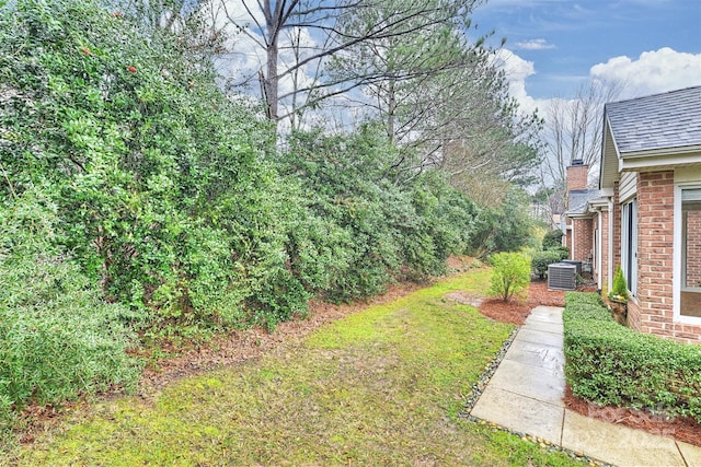 view of yard with central AC unit