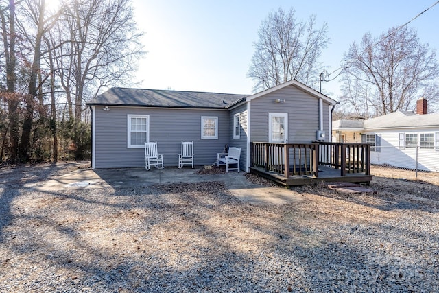 rear view of house featuring a wooden deck