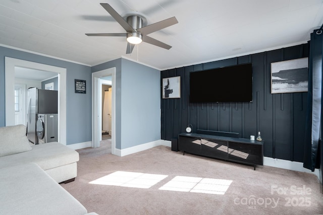 carpeted living room featuring crown molding and ceiling fan