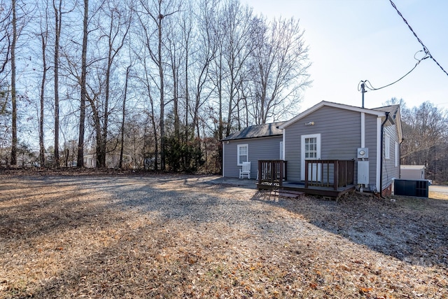 back of house featuring a wooden deck and central AC unit