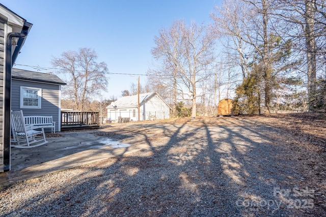 view of yard featuring a wooden deck